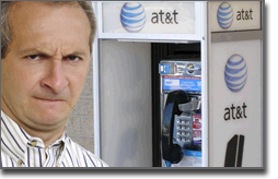 Pictured: one coworker angrily tries to understand the pay phone.